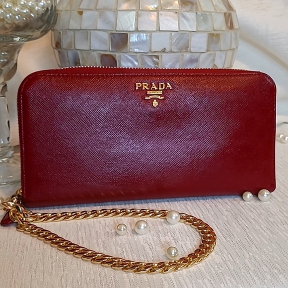 Authentic large Prada red saffiano leather with new gold wrist strap.